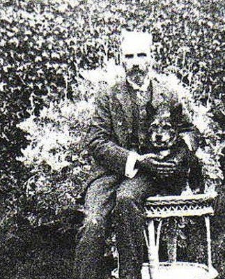 Waterhouse sitting in a garden, with his dog